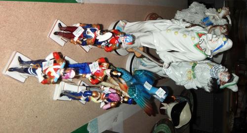 A pair of Continental porcelain figures of clowns, a figure of a lady, and six small soldier figures.
