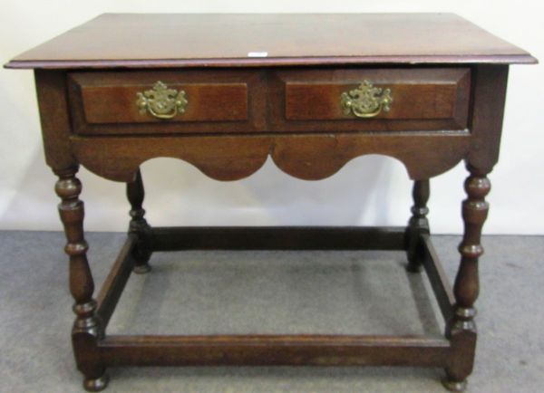 A 17th century and later oak side table, with single drawer on turned supports united by perimeter stretcher, 93cm wide.