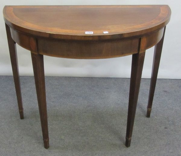 A George III satinwood banded mahogany demi-lune tea table on tapering square supports, 91cm wide.