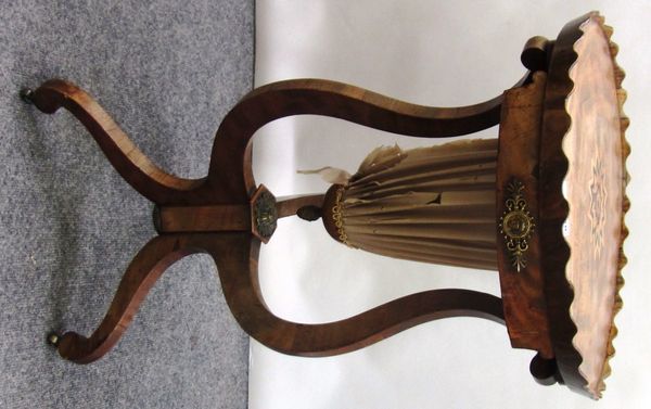 A 19th century French gilt metal mounted mahogany work table, the stellar inlaid galleried circular top on three cabriole supports, centred by a pull