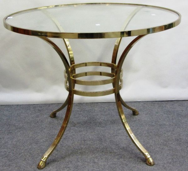 A 20th century gilt metal circular table, with inset glass top on four curved supports, 91cm wide.