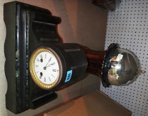 A 19th century eight day black slate mantel clock, a gold twin handled urn and a large silver bauble.