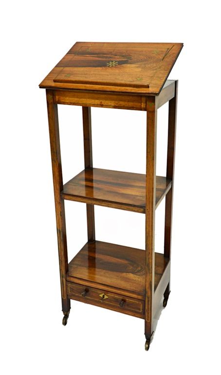 An early 19th century brass inlaid rosewood whatnot cum reading stand, the angle adjustable top over a pair of open tiers, the lower fitted with a dra