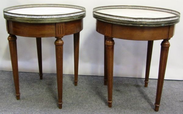 A pair of late 19th century French gilt brass marble topped circular occasional tables, on tapering fluted supports, 45cm wide.