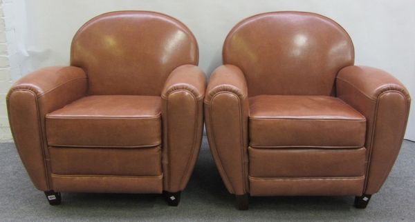 A pair of 20th century Art Deco style faux brown leather upholstered club easy armchairs, on tapering square ebonised supports.