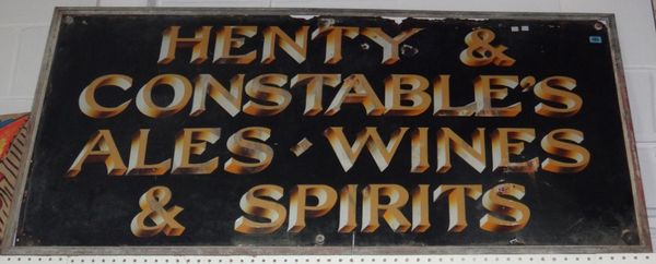 A large enamel sign 'HENTY & CONSTABLES ALES WINES AND SPIRITS'