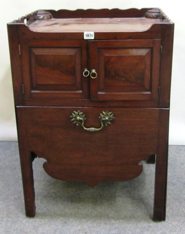 An 18th century mahogany tray top night commode, with pair of panel doors over pull out drawers, on block supports, 53cm wide.