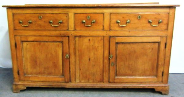 A George III pine dresser base, with three drawers over pair of cupboards, on bracket feet, 159cm wide.