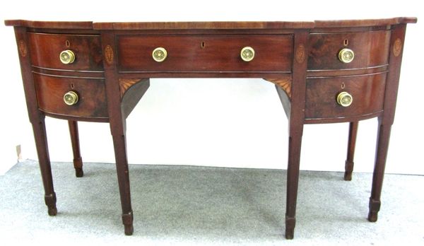 A George III inlaid mahogany bow front sideboard, with four frieze drawers on canted tapering square supports, 160cm wide.