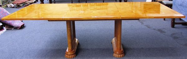 A Biedermeier style line inlaid satin birch extending dining table, on a pair of parquetry inlaid trestle end standards, to include one extra leaf, 11