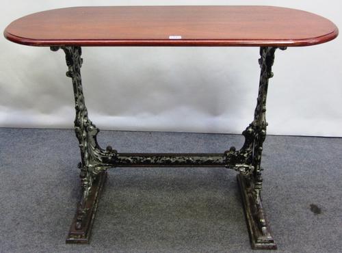 An early 20th century cast iron table base, with a later mahogany rounded rectangular top, 104cm x 49cm.