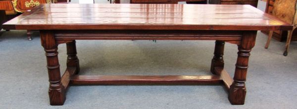 A 17th century style oak refectory table, the cleated plank top on turned supports, 91cm wide x 230cm long.