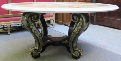 A 20th century circular white and Sienna marble circular segmented inlaid table top, on a brass inlaid ebonised base of four scroll supports, united b