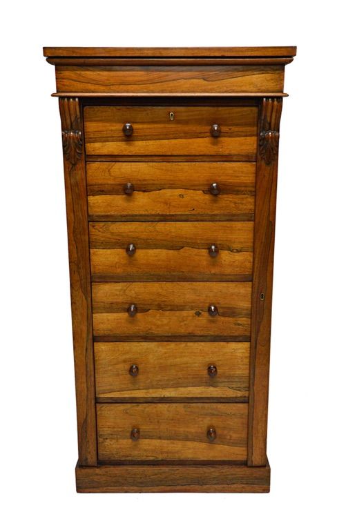 A 19th century rosewood Wellington chest, the six graduated drawers enclosed by scroll mounted locking bar, on plinth base, 61cm wide.  Illustrated
