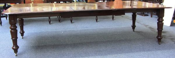 A William IV mahogany extending dining table on lappet carved legs, to include three extra leaves, 138cm wide x 143cm long x 273cm long fully extended