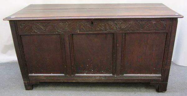 A 17th century oak coffer, the plain top over triple panel front, with carved detail 'RH 1661', 158cm wide.