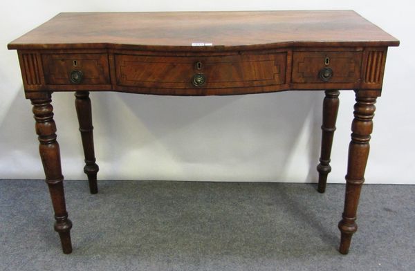 An early Victorian mahogany bow front writing table, with three frieze drawers on turned supports, 106cm wide.