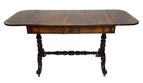 An early 19th century Irish rosewood banded mahogany sofa table, with pair of frieze drawers and dummy opposing, on pair of turned columns and four ac