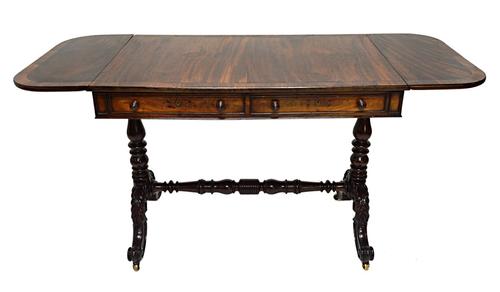 An early 19th century Irish rosewood banded mahogany sofa table, with pair of frieze drawers and dummy opposing, on pair of turned columns and four ac