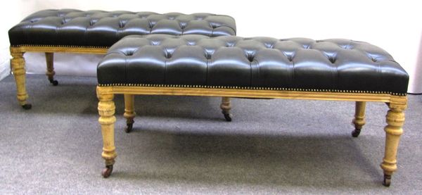 A pair of stripped oak rectangular stools with leather button upholstered tops, 118cm wide.