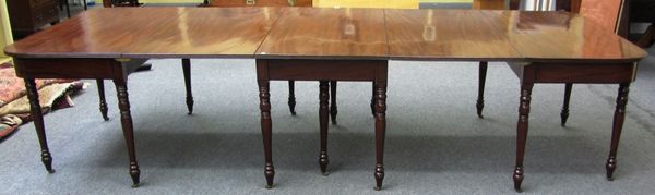 A Regency mahogany triple section extending dining table, to comprise two D end consoles and a drop flap centre section, 135cm wide, each console 66cm