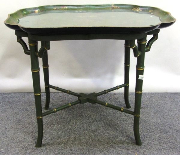 An early Victorian shaped rectangular green ground chinoiserie decorated tray, on a later faux bamboo stand, 62cm wide.