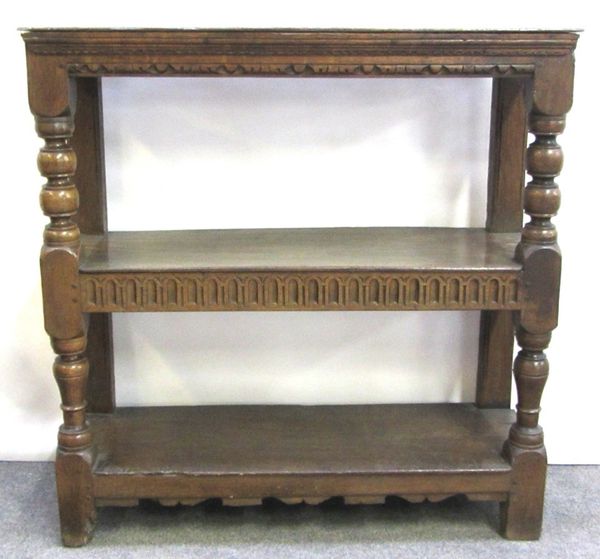 An 18th century and later carved oak three tier buffet on baluster turned supports, 100cm wide.