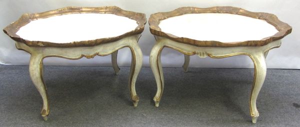 A pair of 18th century Italian style cream painted and parcel gilt shaped circular occasional tables, on cabriole supports, 85cm wide.