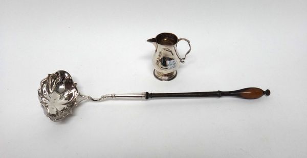 A silver cream jug, of baluster form, with a scrolling handle and on a circular foot, the hallmarks indistinct and a George II silver toddy ladle, hav