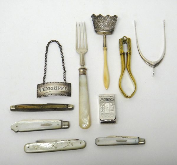 A silver caddy spoon, the bowl formed as a basket of flowers, with a turned ivory handle, Birmingham 1822, a rectangular plated decanter label, detail