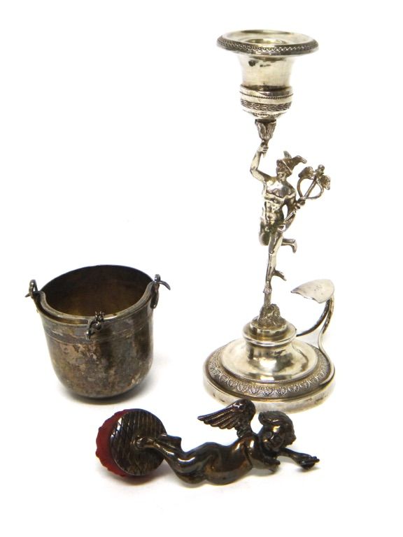 An Italian single candle holder, the stem formed as the figure of Mercury raised on a circular base, with a thumbpiece, having a shield shaped termina