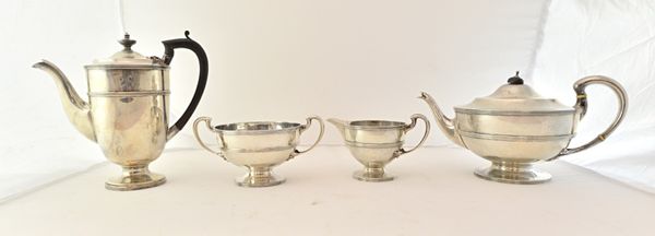 A silver composite four piece tea and coffee set, each piece of circular form, decorated with reeded bands, comprising; the teapot, the twin handled s