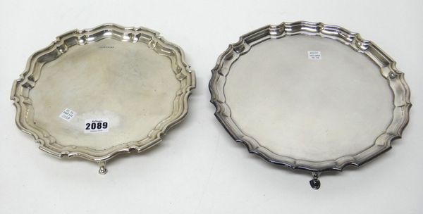 A silver salver, of shaped circular form, in the Chippendale style, raised on three feet, diameter 24.5 cm, Sheffield 1927, weight 431 gms and a plate