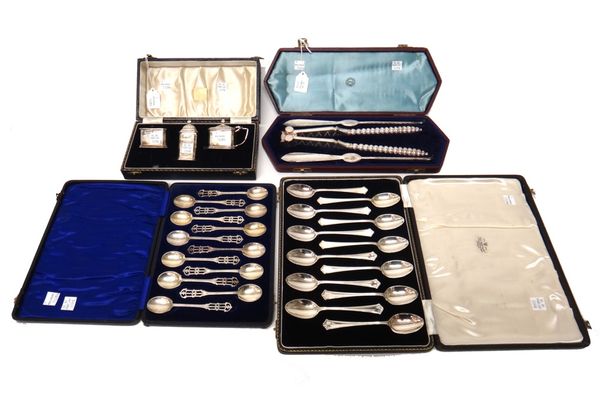 A set of twelve silver coffee spoons, the handles with pierced decoration, Birmingham 1927, a silver three piece condiment set, comprising, a mustard