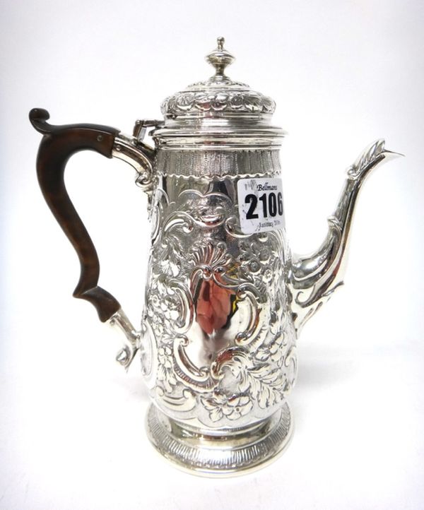 A silver small coffee pot, of tapered cylindrical form, with later floral, foliate and scroll embossed decoration in the rococo style, on a circular f