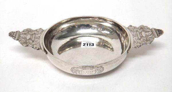 A French provincial silver ecuelle, the bowl of circular form, engraved Claude Cornau within a rococo cartouche, the cast handles decorated with male