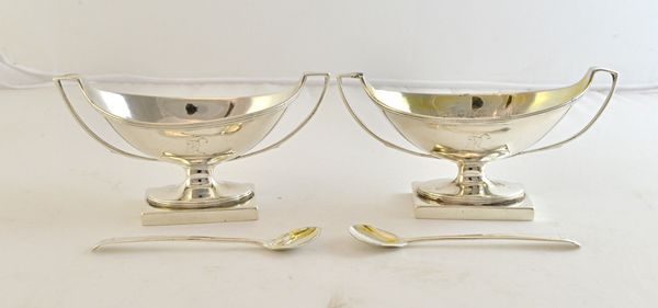 A pair of silver twin handled salts, each of boat shaped form, with reeded rims and raised on a rectangular base, London 1796 and a pair of silver Old