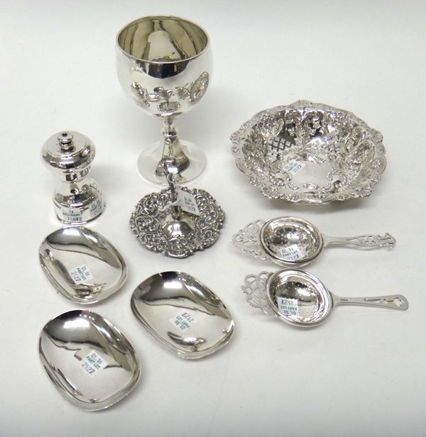 Silver, comprising; a trophy goblet, Birmingham 1922, a shaped circular bonbon dish, with embossed and pierced decoration, Sheffield 1897, a ring tree