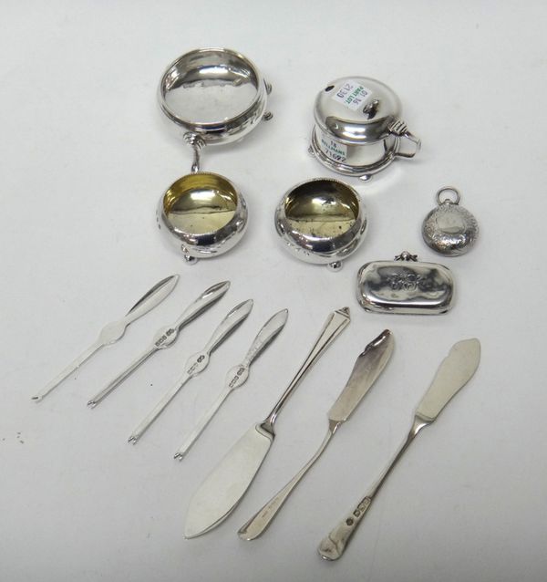 Silver, comprising; a pair of circular salts, each raised on three spherical feet, Birmingham 1892, a mustard pot frame (the liner lacking), a circula