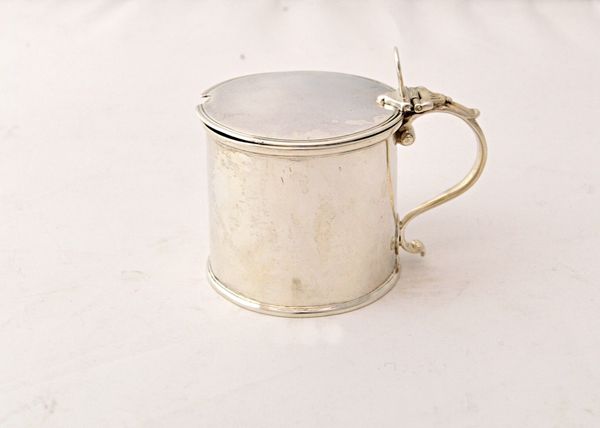 A George II silver hinge lidded mustard pot, of plain cylindrical form, having a flat lid, Newcastle 1756, weight 144 gms, with a later frosted glass