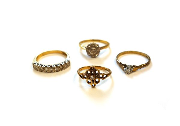 A gold and platinum, diamond set nine stone cluster ring, a gold and diamond set single stone ring, another gold and diamond set single stone ring, in