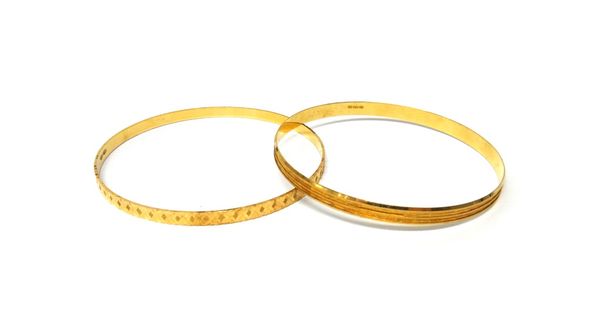 Two gold circular bangles, with differing engraved decoration to each, combined weight 16 gms.