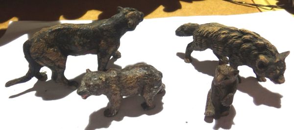 A group of four small Black Forest carved animals.