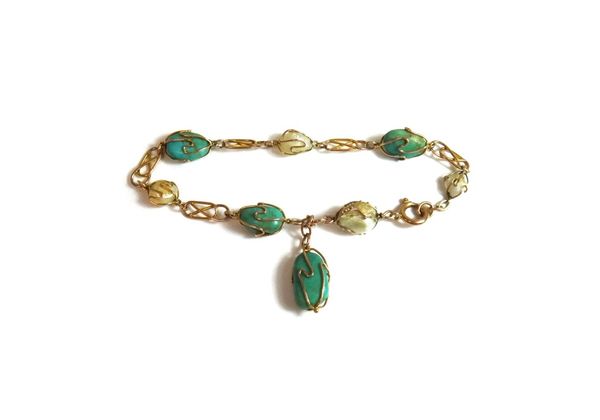 A gold, turquoise and freshwater cultured pearl bracelet, in a multiple link design, with a turquoise pendant drop, on a boltring clasp, circa 1910.