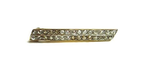 A gold and diamond set brooch, designed as two rows of cushion shaped diamonds, length 4 cm, with a case.