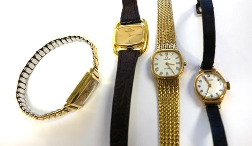 A lady's gold cased Jaeger-Le Coultre wristwatch, of oval form, on a strap, a lady's 18ct gold rectangular cased Movado wristwatch, import mark London