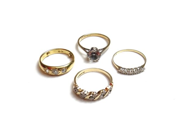 A gold and diamond set three stone ring, gypsy set with cushion shaped diamonds, a 9ct gold and diamond set ring, mounted with five pairs of small cir