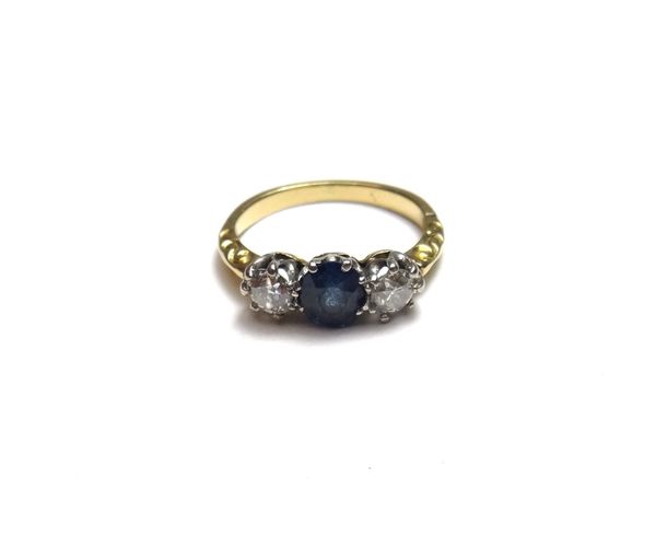 A gold, sapphire and diamond set three stone ring, claw set with the oval cut sapphire at the centre, between two cushion shaped diamonds, ring size H