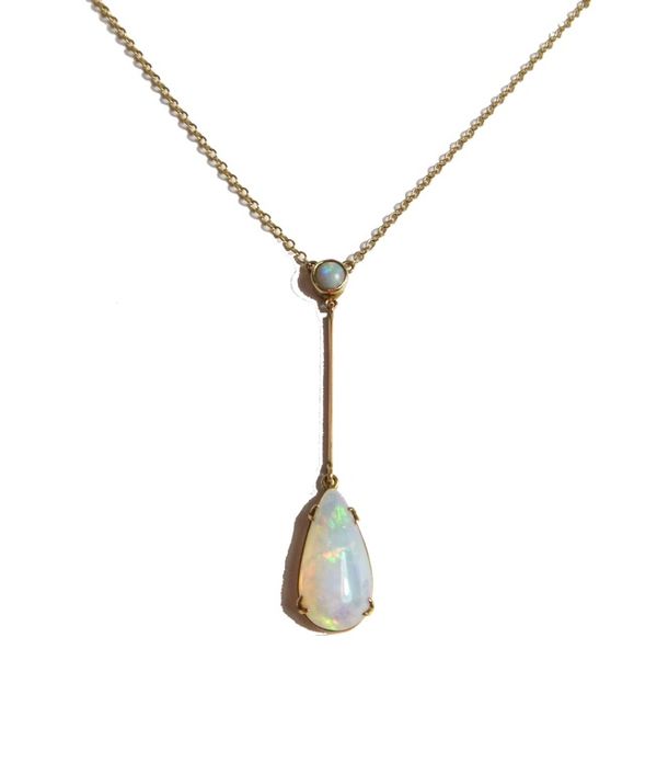 A gold and opal set two stone pendant necklace, claw set with the principal drop shaped opal to the terminal and with a smaller circular opal mounted