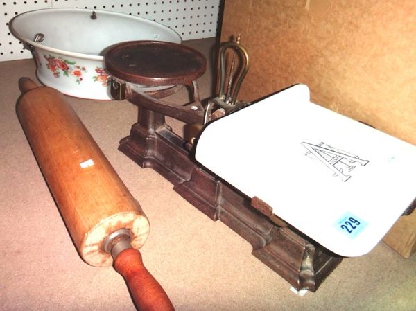 A cast iron and ceramic weighing scale, a glass lampshade and a rolling pin.